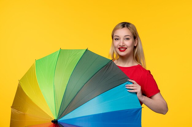 Frevo cute blonde girl celebrating brazilian festival covering herself with umbrella