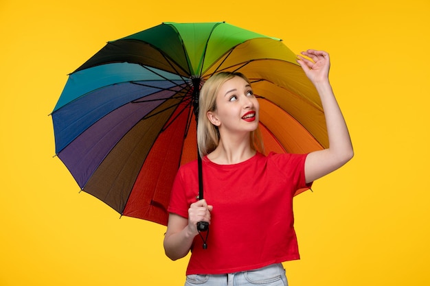 Free photo frevo cute blonde girl celebrating brazilian festival touching edges of umbrella