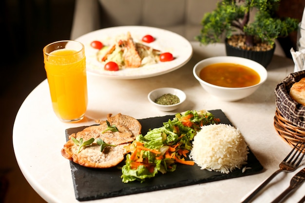 Fried chicken breast served with lettuce salad and rice