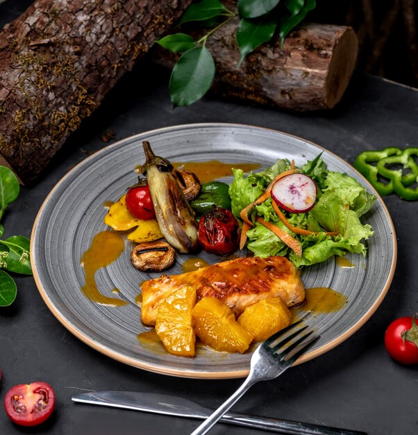 Fried chicken breast with vegetables and fruits