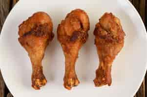 Free photo fried chicken legs on a white plate