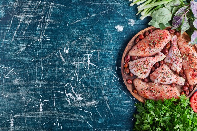 Fried chicken meat on a wooden board with spices.