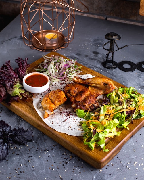 Fried chicken tabaca on wooden board