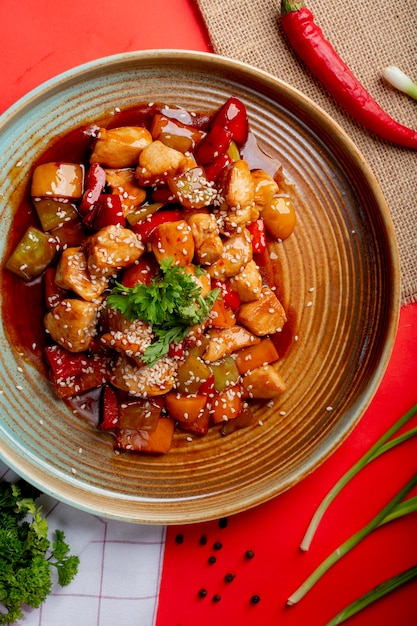 Fried chicken and vegetables in sauce with sesame