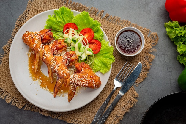 Fried chicken wings with fish sauce and sweet fish sauce.