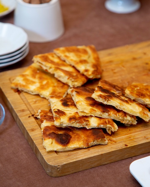 Fried crepes on wooden board