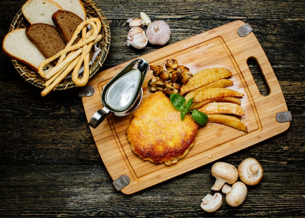 Fried cutlet with potatoes and mushrooms