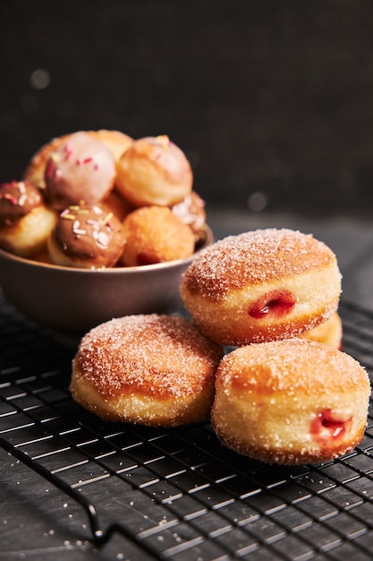 Free Photo fried donuts with sugar and cream on a black table