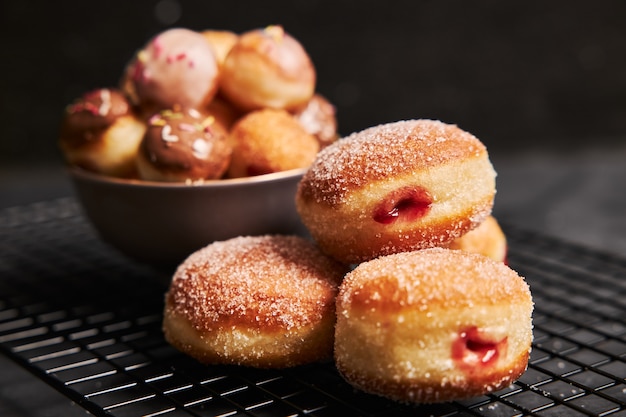 Free Photo fried donuts with sugar and cream on a black table