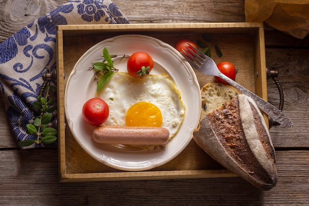 Fried egg with hotdog and bread