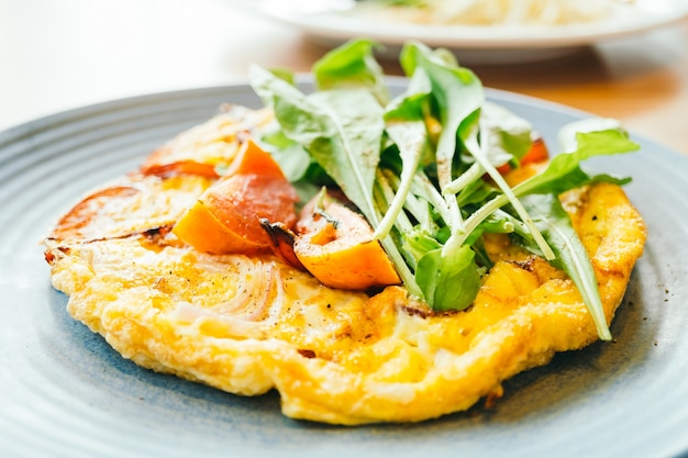 Fried eggs omelette in white plate