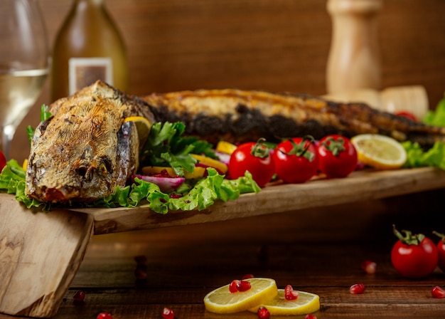 Fried fish with vegetables on the table