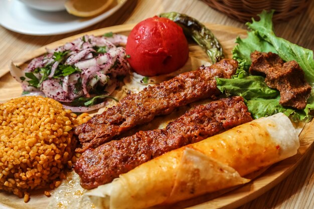 Fried meat lula with sliced onion with herbs and bread