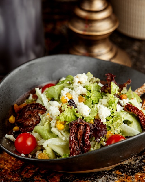 Fried meat pieces and herbs salad