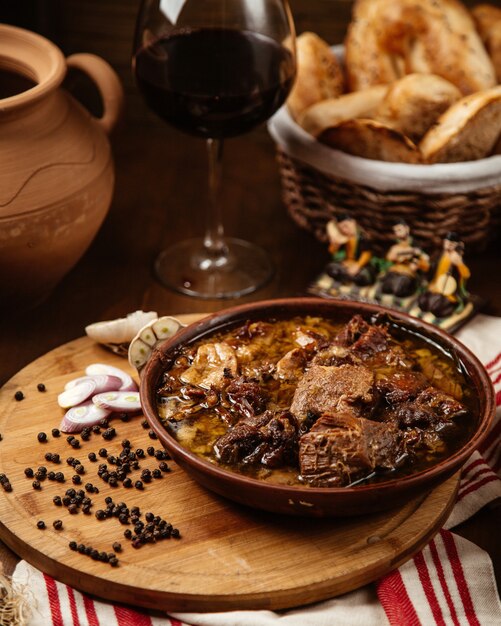 Fried meat in pot and pepper seeds