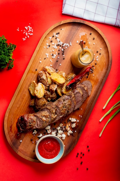 Fried meat slices with potatoes and mustard