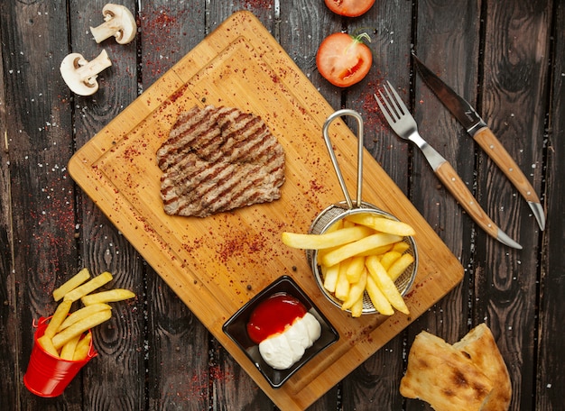 Fried meat with french fries top view