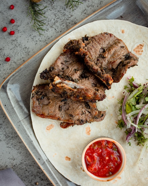 fried meat with onion greens and sauce