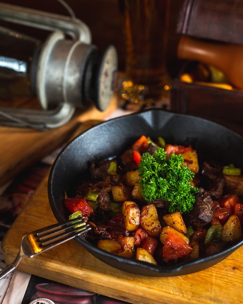 Fried meat with potatoes bell peppers and greens 1