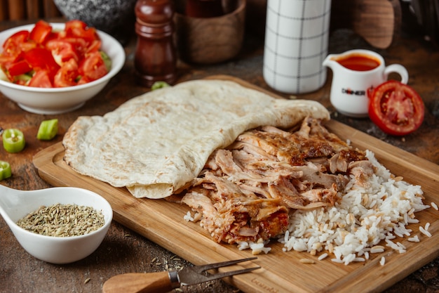 fried meat with rice on a wooden stand