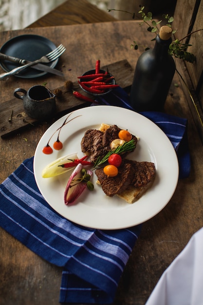 Fried meat with vegetables in the plate