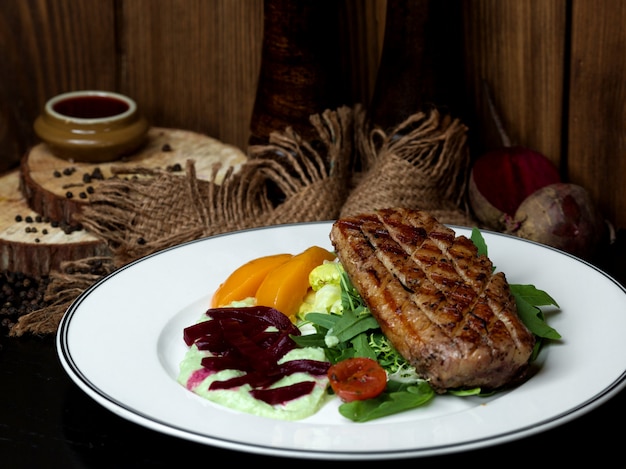 Fried meat with vegetables on the table