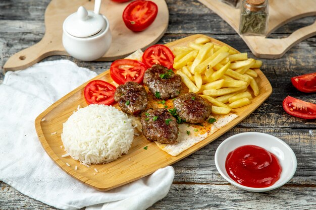 Fried meatballs  with rice  french fries  side view