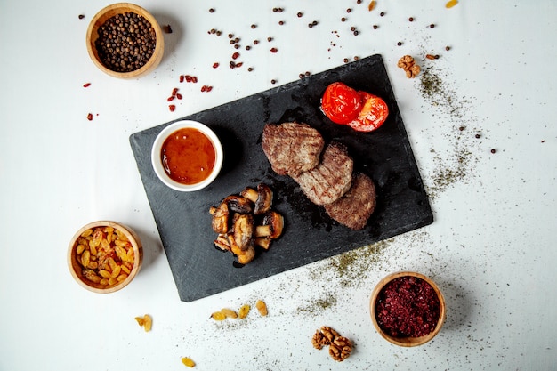 Fried pieces of meat and fried mushrooms