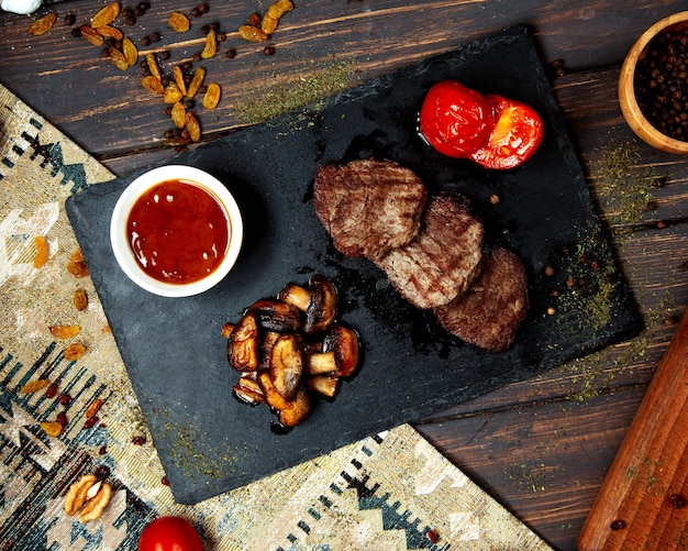 Fried pieces of meat and fried mushrooms