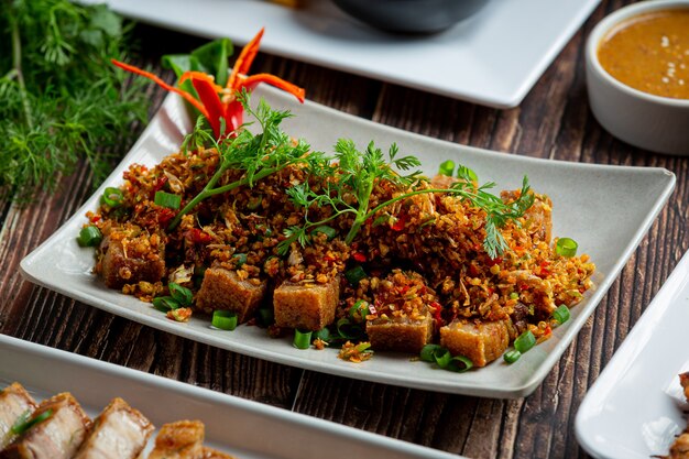 Fried Pork with Dried Chili and Salt on dark background