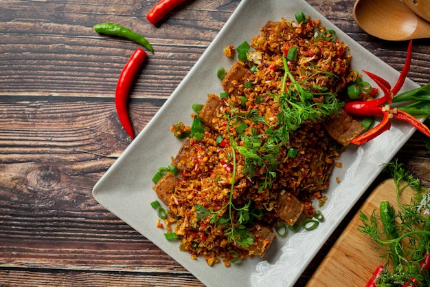 Fried Pork with Dried Chili and Salt on dark background