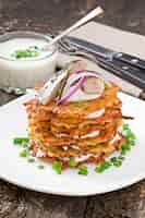 Free photo fried potato pancakes  with herring