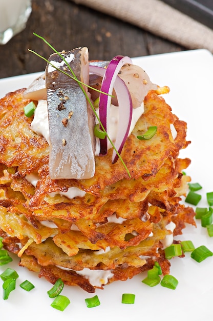 Free photo fried potato pancakes  with herring