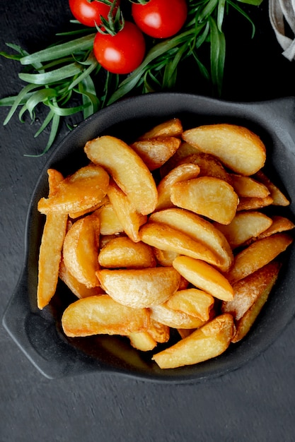 Fried potatoes with tomatoes and greens