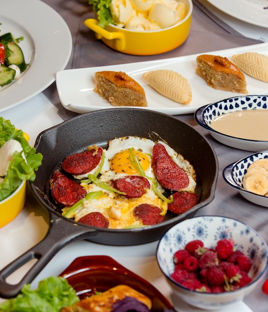 Fried sausage with eggs on the table