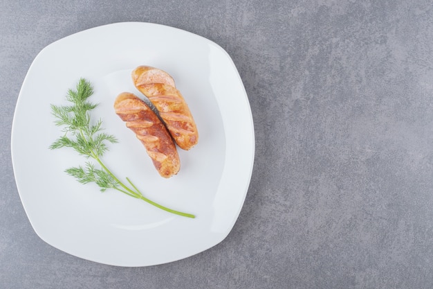 Fried sausages in a white plate