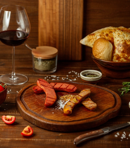 Fried sausages on wooden board