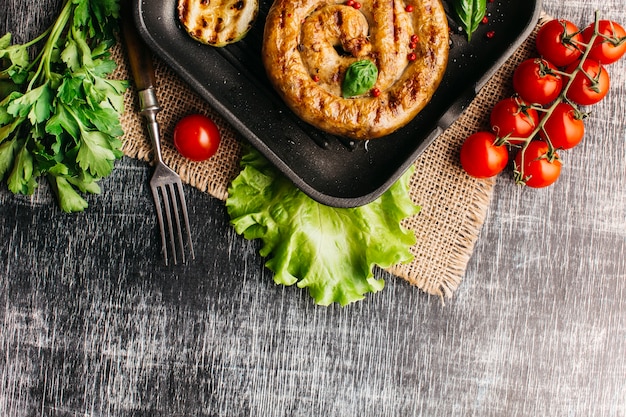 Free photo fried snail sausage with spices in pan