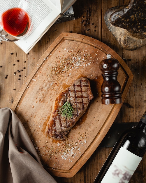 Fried steak on wooden board