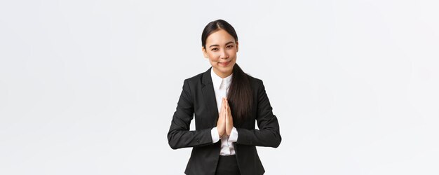 Friendly asian businesswoman hold hands together and bowing at business partners greeting clients fe