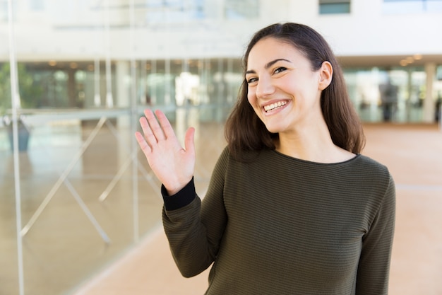 Free photo friendly happy latin woman waving hello