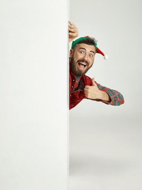 Free Photo friendly man dressed like a funny gnome posing on an isolated gray