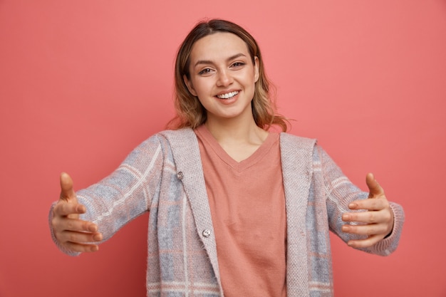 Friendly young girl doing welcome gesture 