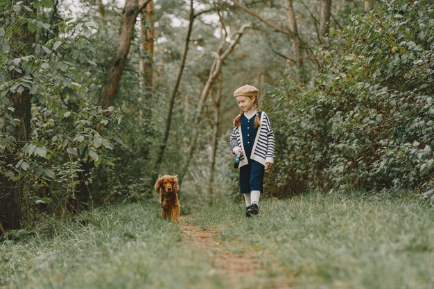 Friends are having fun in the fresh air. Child in a blue dress.