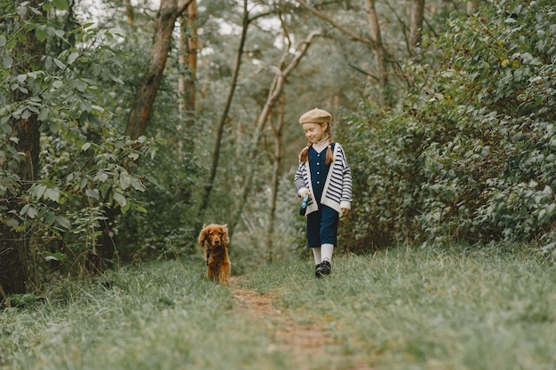 Friends are having fun in the fresh air. Child in a blue dress.