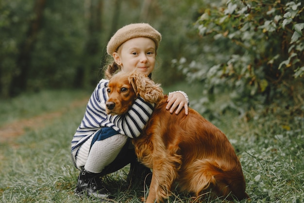 Friends are having fun in the fresh air. Child in a blue dress.