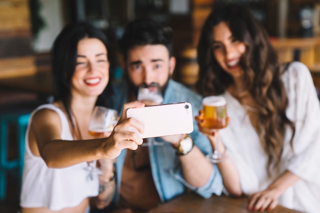 Friends in bar taking selfie