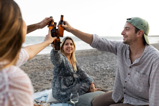 Friends at the beach with beer bottles