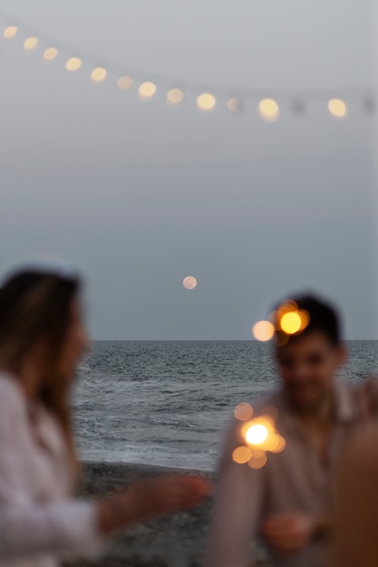 Free photo friends at the beach with sparklers