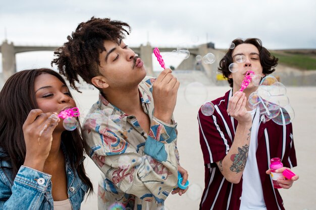 Friends blowing bubbles while out in the city